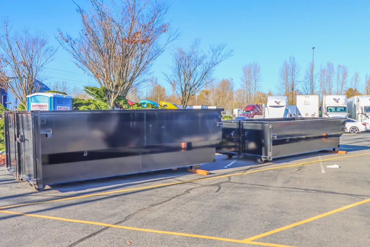 Professional dumpster rental service with roll-off container on residential driveway in Inver Grove Heights